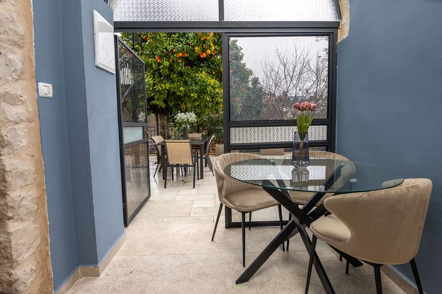 Blue archway sitting area with sofa and armchairs