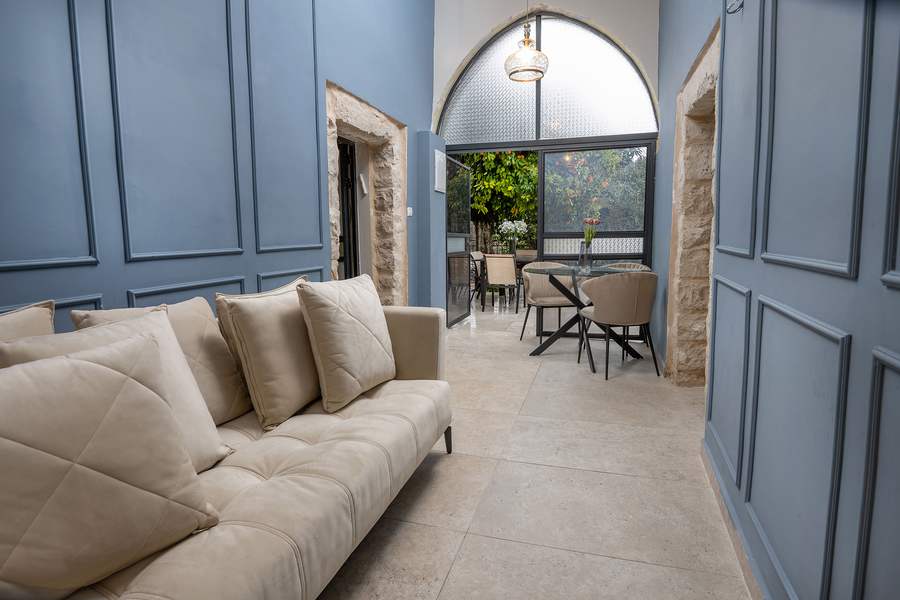 Blue-toned room with glass table and chairs