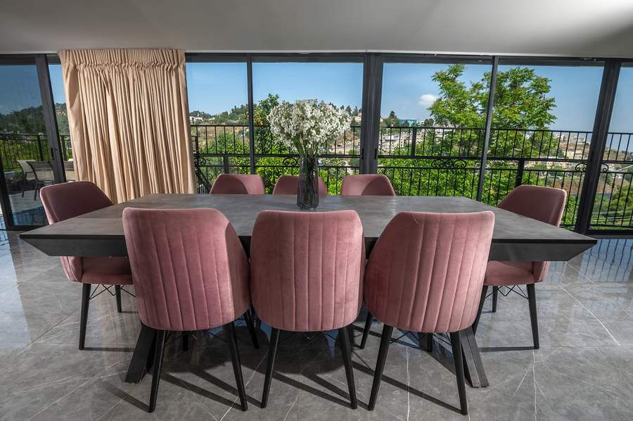 Dining table seating eight with balcony view