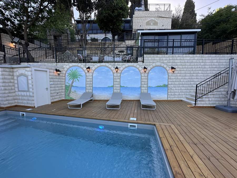 Heated pool with beach mural arches