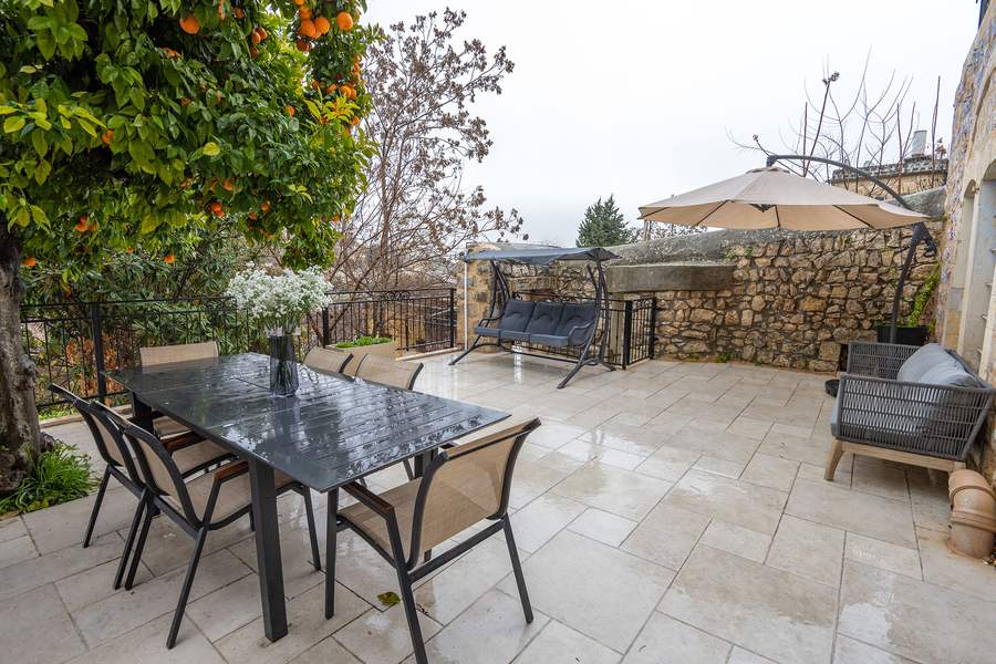 Terrace dining table with lounge seating and mountain view