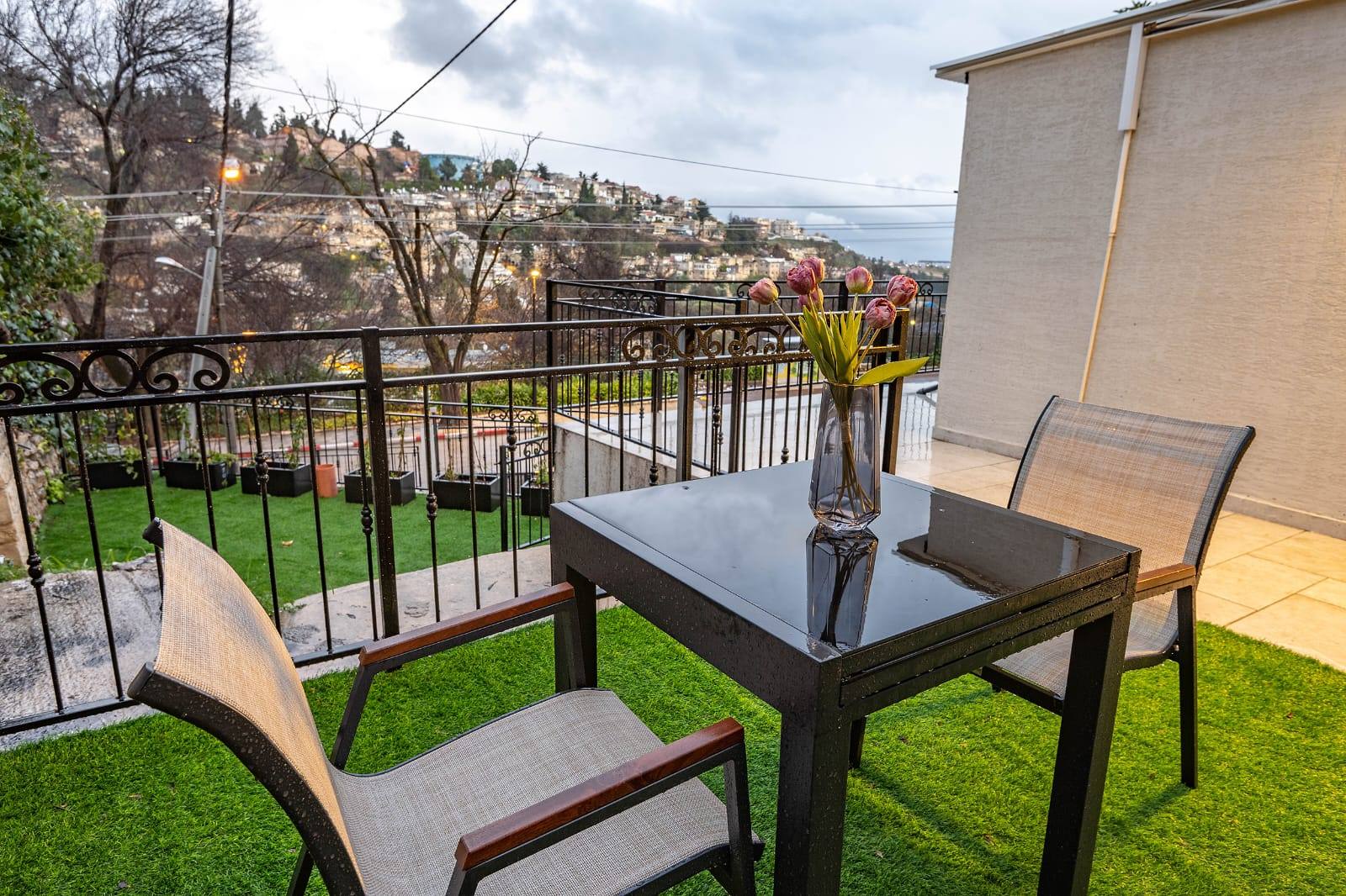 Private balcony table with flowers overlooking Tzfat